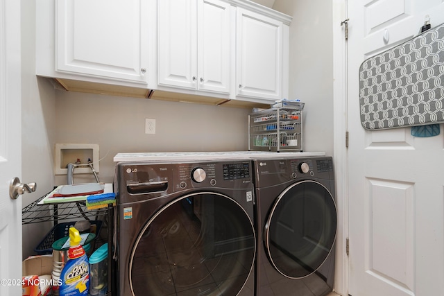 washroom featuring washing machine and clothes dryer and cabinets