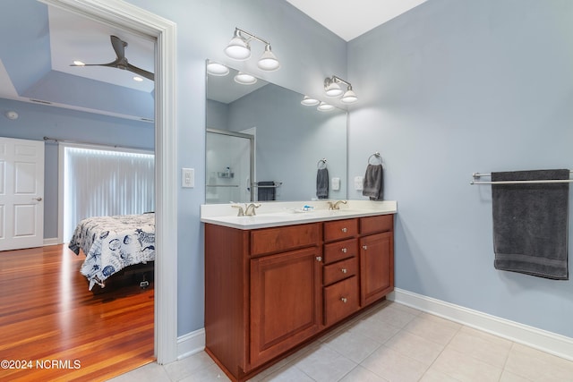 bathroom featuring ceiling fan, hardwood / wood-style flooring, vanity, and an enclosed shower