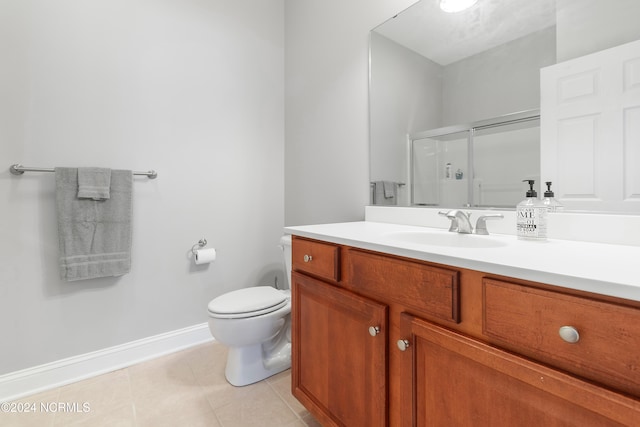 bathroom with tile patterned floors, a shower with shower door, vanity, and toilet