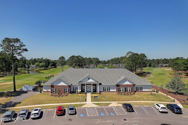 view of front facade featuring a water view and a front yard