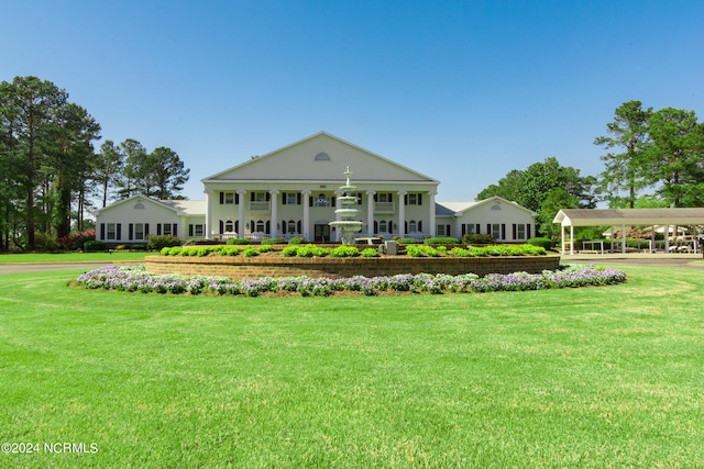 rear view of house with a yard