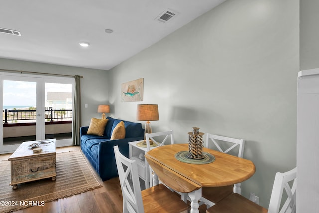 dining space with wood-type flooring