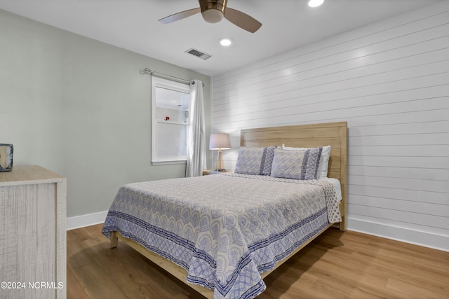 bedroom with wood-type flooring and ceiling fan