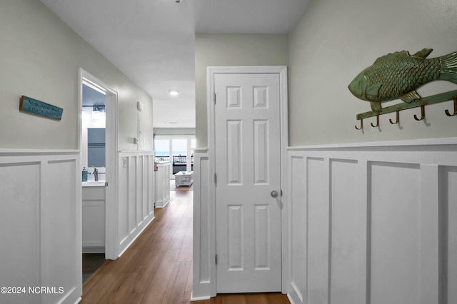 hallway with dark hardwood / wood-style flooring