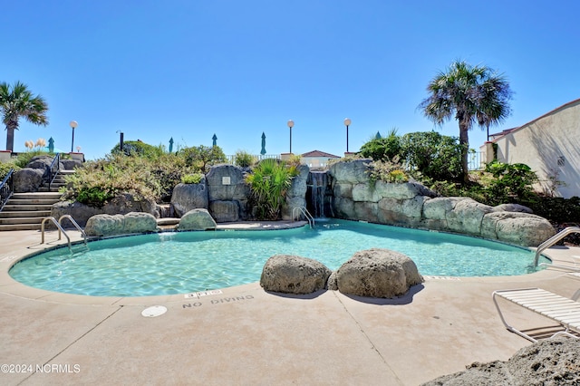 view of pool featuring pool water feature