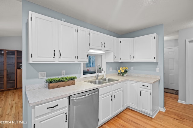 kitchen featuring light hardwood / wood-style flooring, white cabinetry, stainless steel dishwasher, and sink