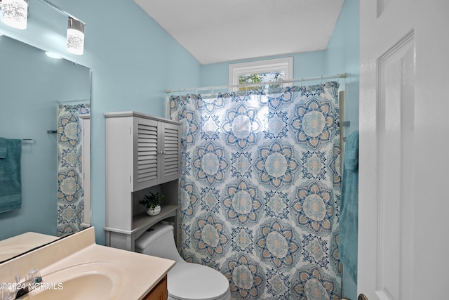 bathroom with vanity, a shower with shower curtain, and toilet