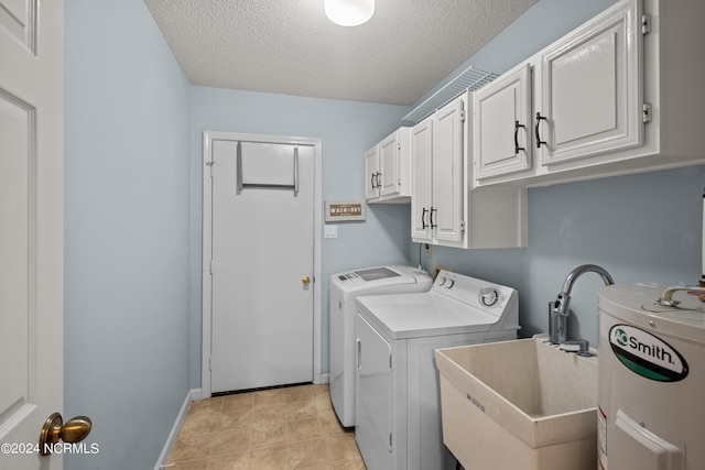 laundry room with cabinets, a textured ceiling, water heater, sink, and independent washer and dryer