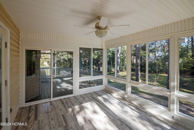 unfurnished sunroom with ceiling fan