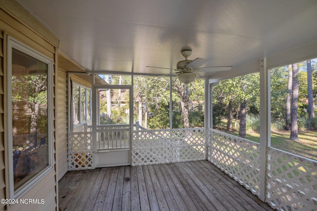 unfurnished sunroom with ceiling fan