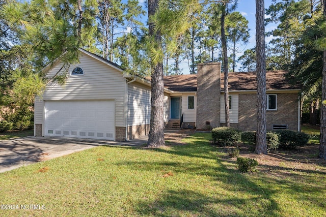 ranch-style home with a garage and a front yard