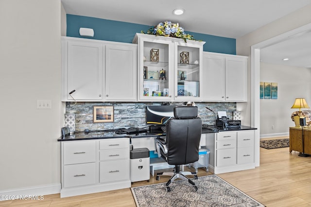 office space featuring light wood-type flooring and built in desk