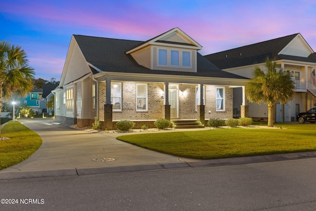 view of front of home featuring a lawn and covered porch