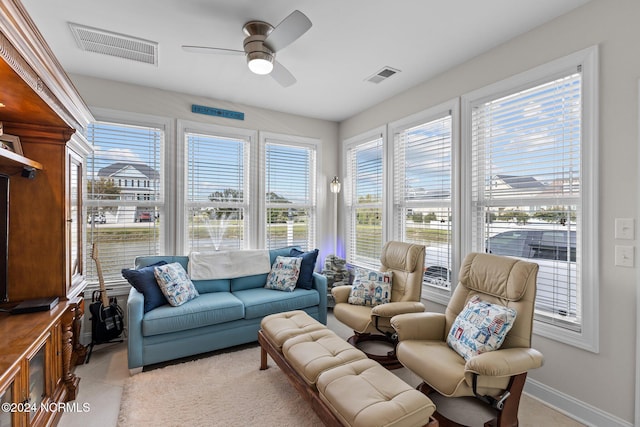 interior space with ceiling fan and light colored carpet