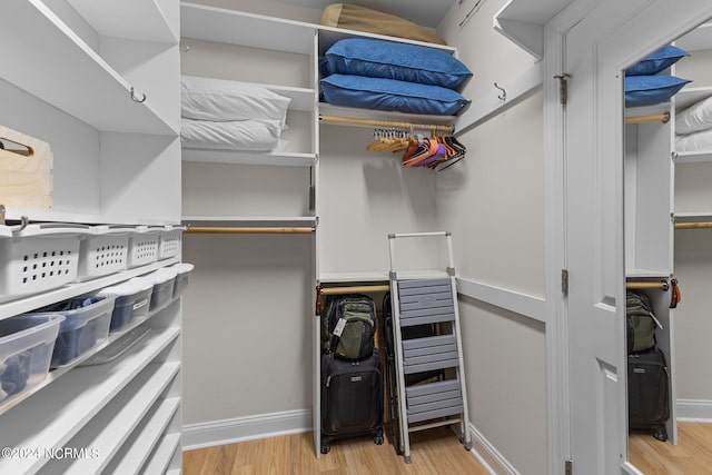 walk in closet featuring light hardwood / wood-style floors