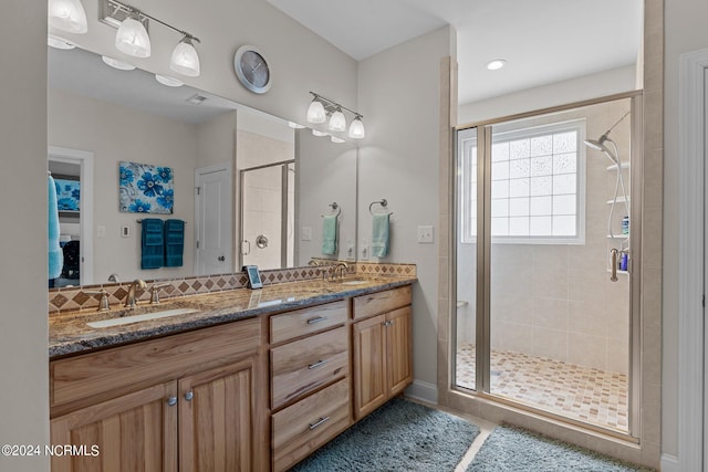 bathroom featuring vanity and a shower with shower door