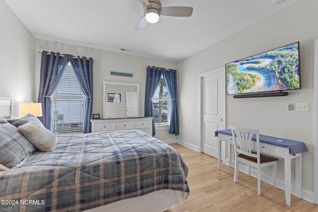 bedroom with light hardwood / wood-style flooring and ceiling fan