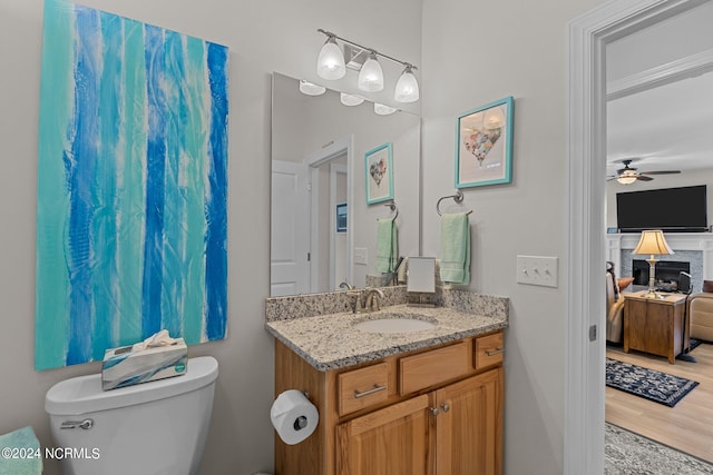 bathroom with vanity, ceiling fan, hardwood / wood-style floors, and toilet