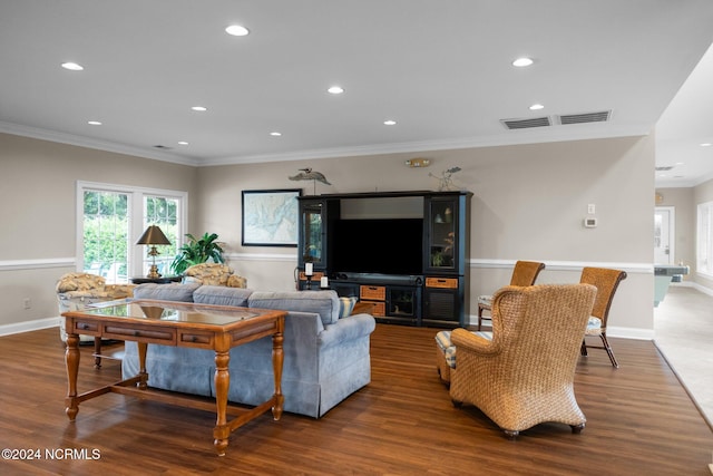 living room featuring ornamental molding and dark wood-type flooring