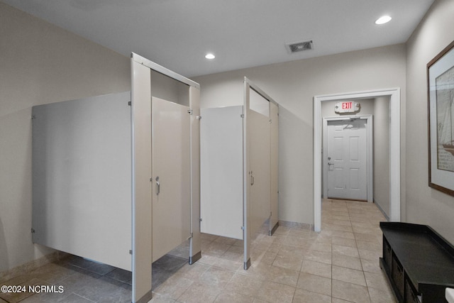 hall with light tile patterned floors