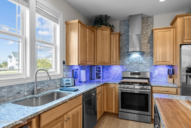 kitchen featuring stainless steel appliances, tasteful backsplash, and wall chimney range hood