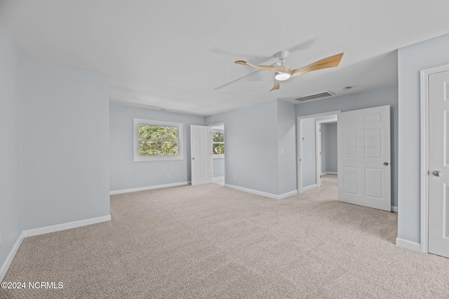 carpeted empty room with ceiling fan