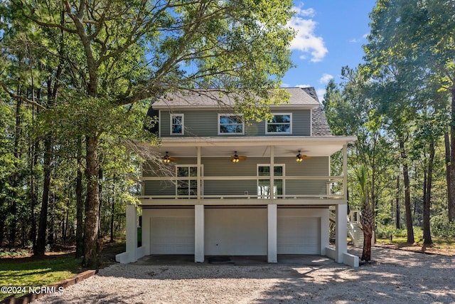 view of front of house featuring ceiling fan and a garage