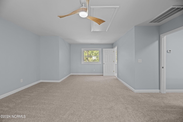 unfurnished room featuring light carpet