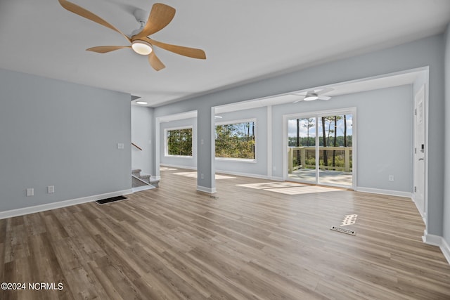 unfurnished living room featuring light wood-type flooring and ceiling fan