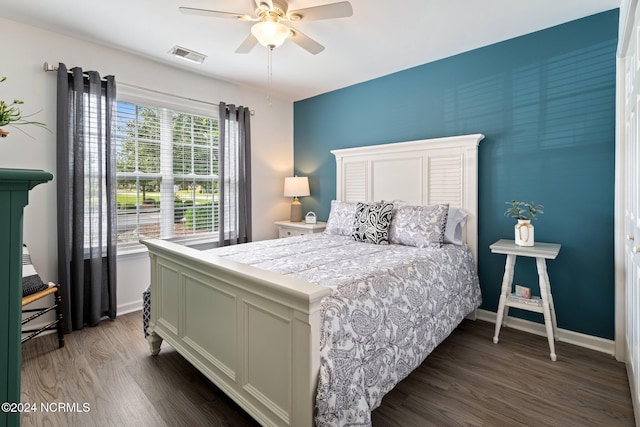 bedroom with ceiling fan and dark wood-type flooring