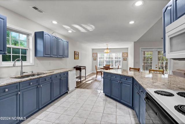 kitchen featuring white appliances, blue cabinets, sink, and light stone counters