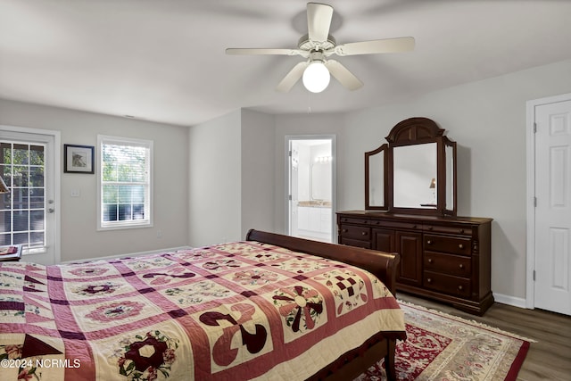 bedroom with ceiling fan, connected bathroom, and dark wood-type flooring