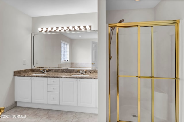 bathroom featuring walk in shower, vanity, and tile patterned flooring