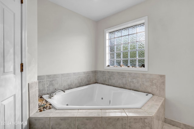 bathroom featuring a relaxing tiled tub