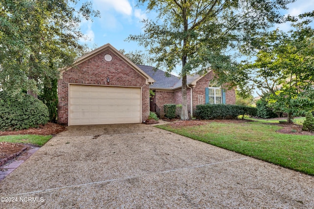 view of front of property with a front yard and a garage