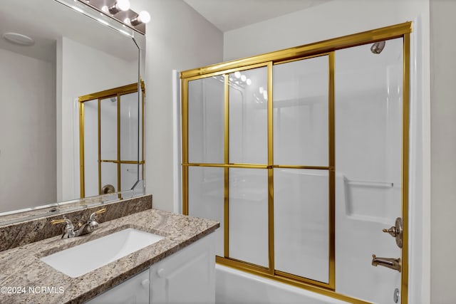 bathroom featuring vanity and shower / bath combination with glass door