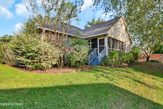 exterior space with a sunroom and a front lawn