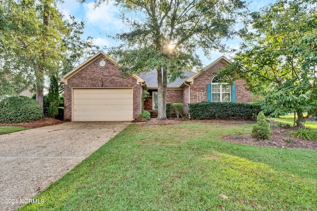 view of front of property with a garage and a front yard