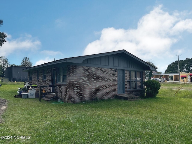 view of side of home with a lawn