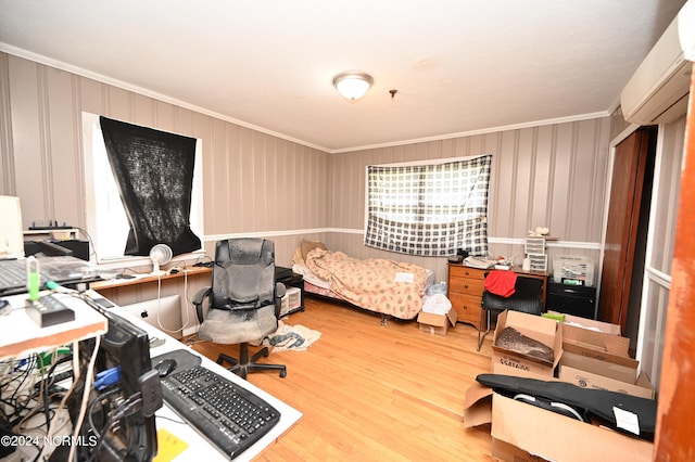 interior space with hardwood / wood-style flooring, ornamental molding, and an AC wall unit