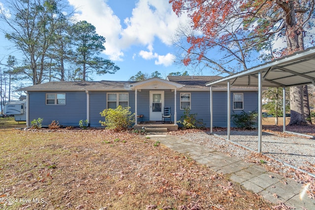 ranch-style home featuring a carport