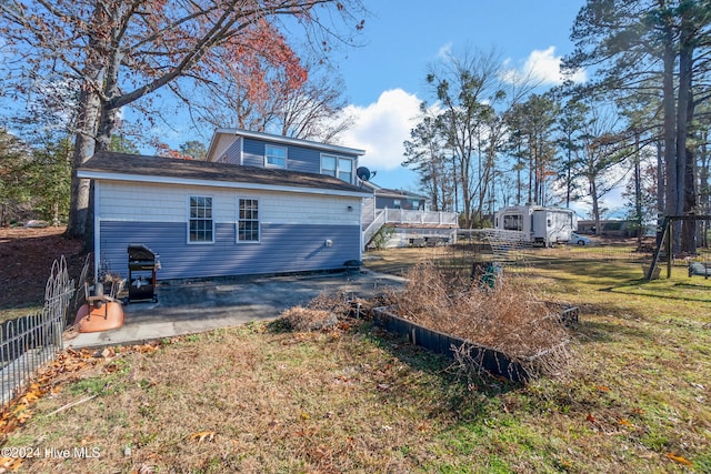 rear view of house with a patio area and a lawn