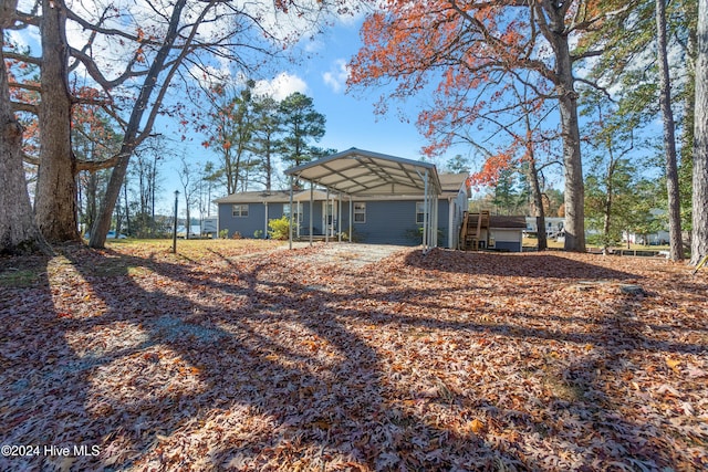 back of house with a carport