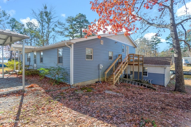 rear view of property featuring a deck