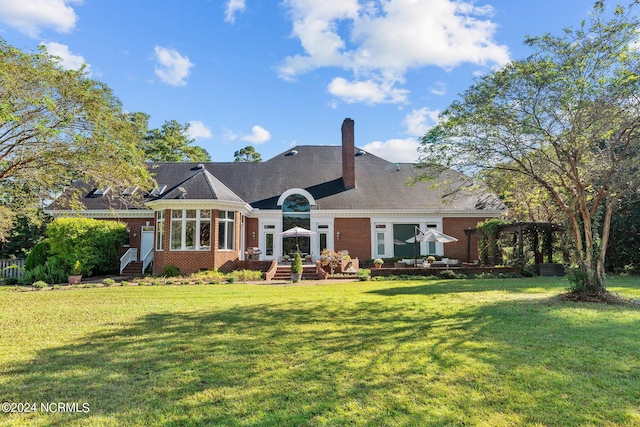 rear view of house with a yard