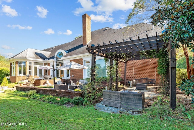 rear view of property with a patio, a yard, a pergola, outdoor lounge area, and a sunroom