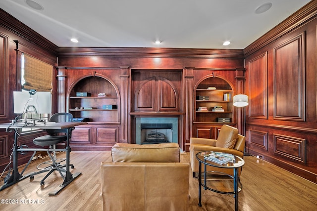 office with built in shelves, light wood-type flooring, and crown molding