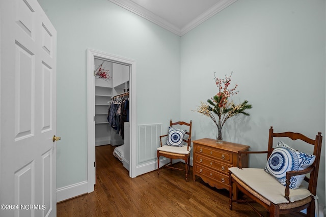 living area with crown molding and dark hardwood / wood-style flooring