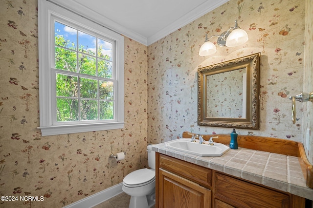 bathroom with crown molding, vanity, and toilet