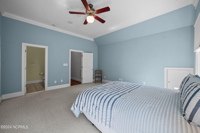 bedroom featuring lofted ceiling, carpet floors, ensuite bathroom, crown molding, and ceiling fan